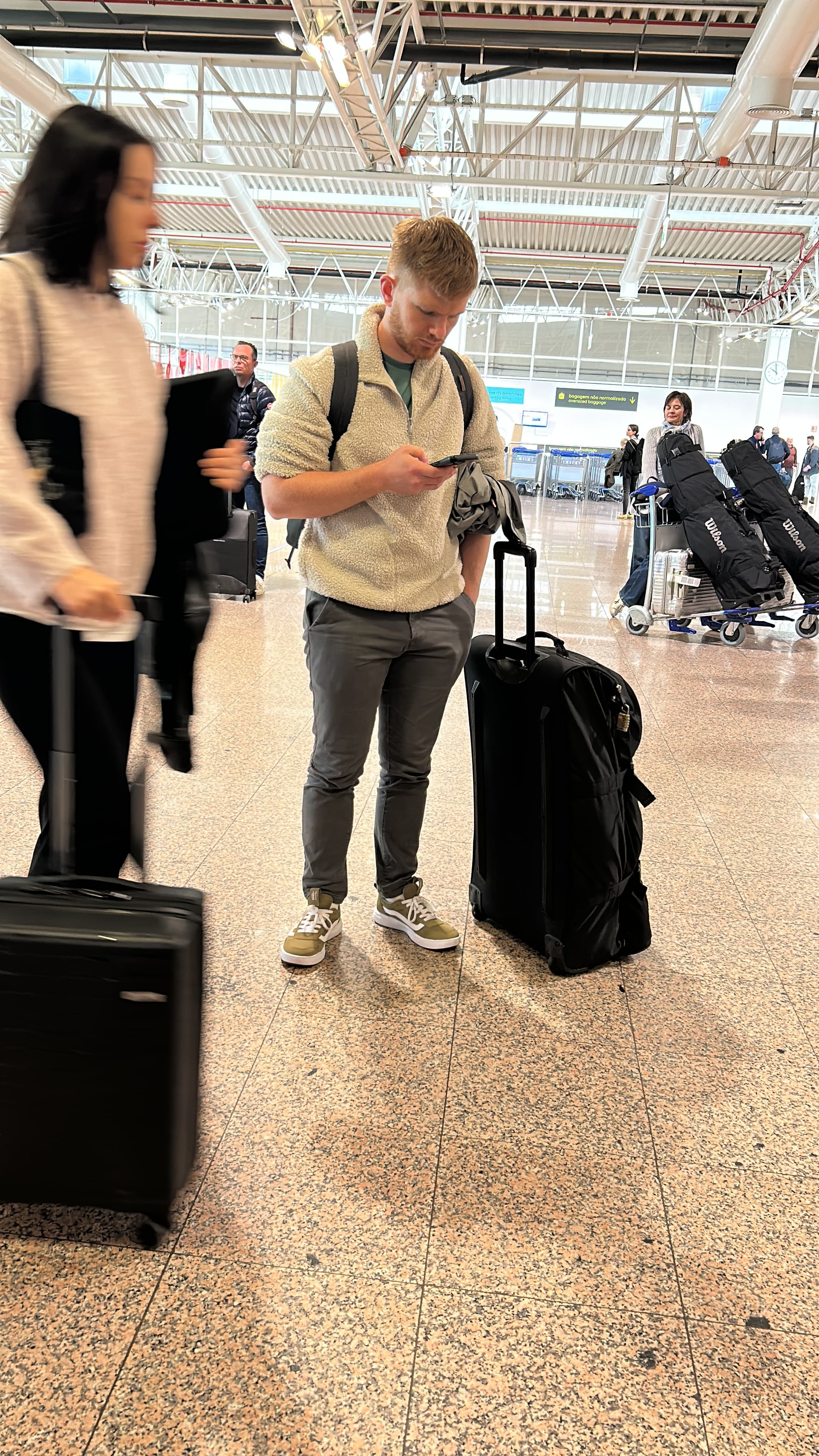 Francois Olwage at the airport, pausing with a phone in hand
