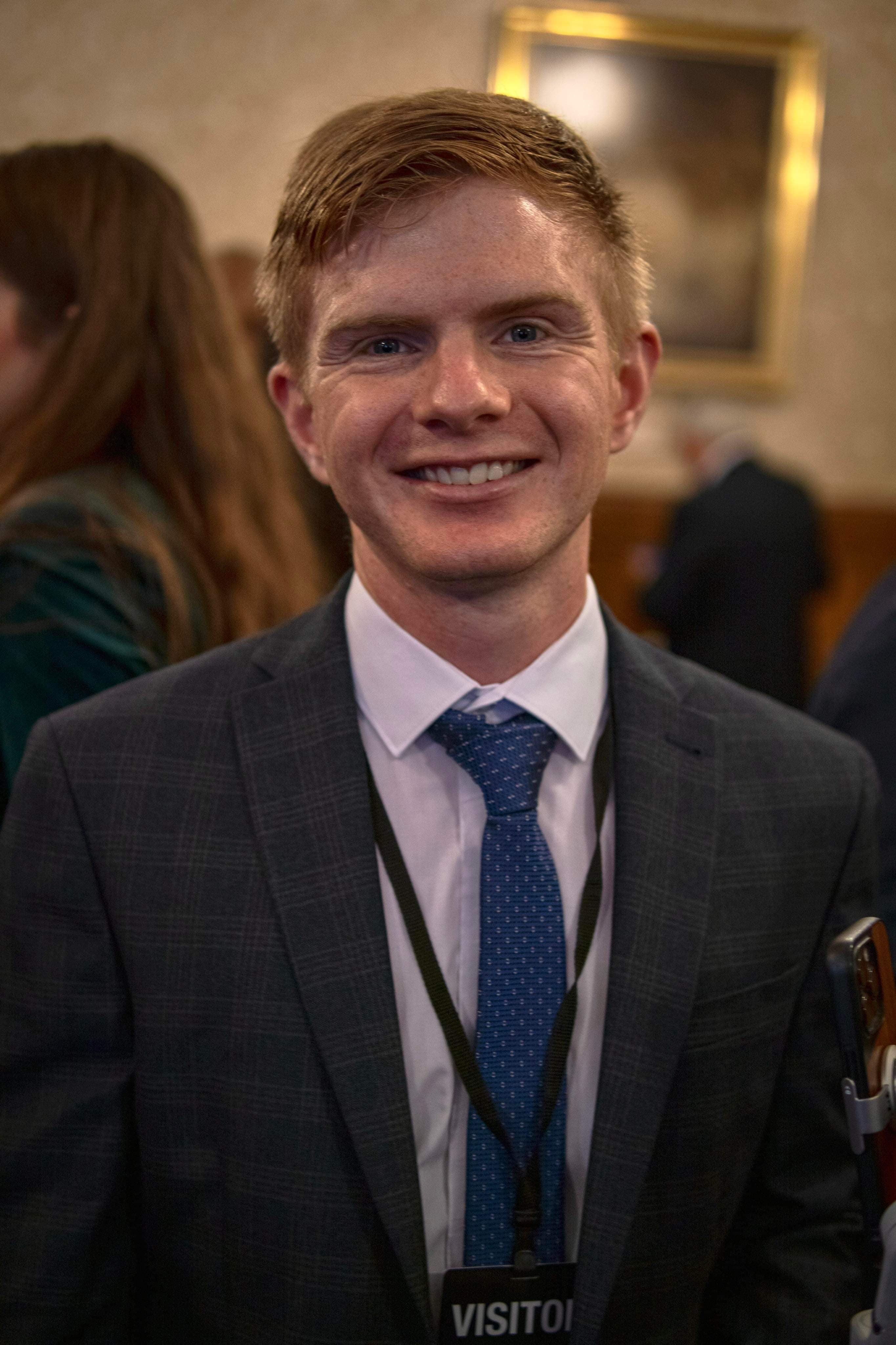 Francois Olwage in a charcoal suit, smiling at an event